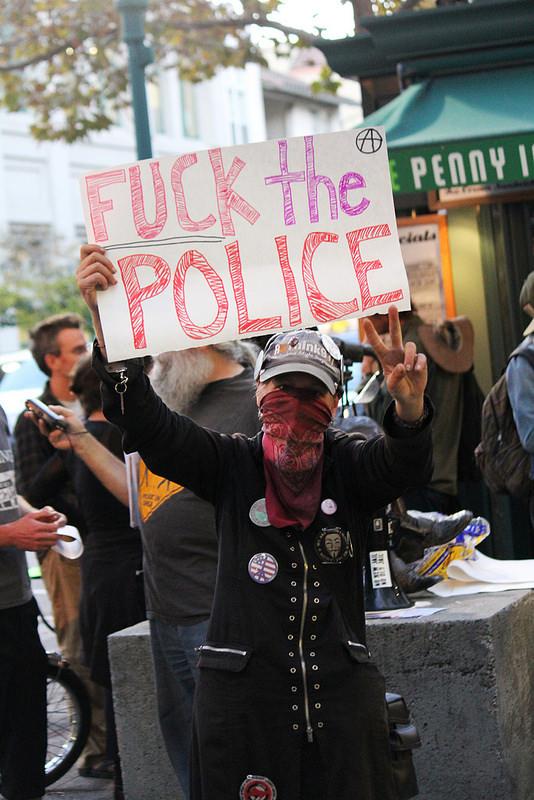 Women standing in front of Book Shop Santa Cruz, protesting Salinas Police Cheif's visit   