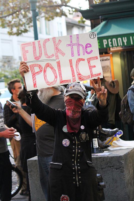 Women standing in front of Book Shop Santa Cruz, protesting Salinas Police Cheifs visit   