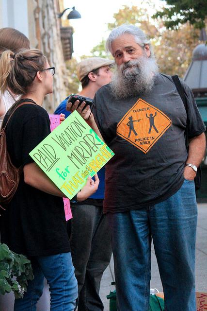 Robert Norse, local political activist and radio show host, joining the protest while seeking Cop Watch volunteers.  